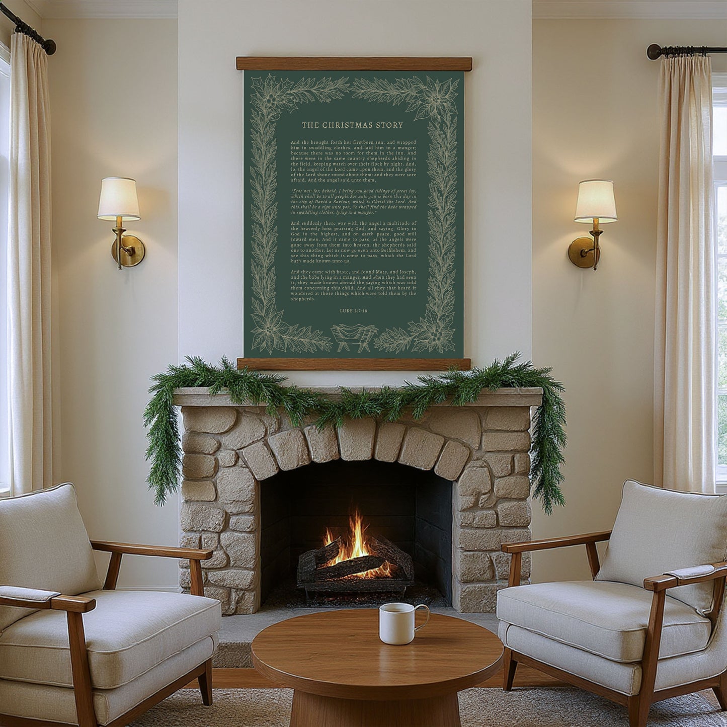a cozy living room with a fireplace, a wooden coffee table, and two white armchairs arranged around the table. Above the fireplace hangs a framed green and white poster with a Christmas-themed message.